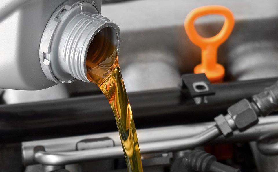 Engine oil is being poured in to the vehicle engine